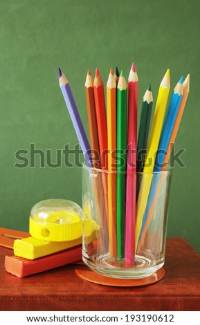 Colorful pencil on book over backboard. Teacher\'s Day concept