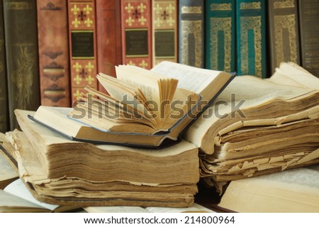 Old open books on bookshelf