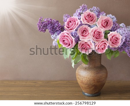 Still life with huge bunch of lilac and roses in vase