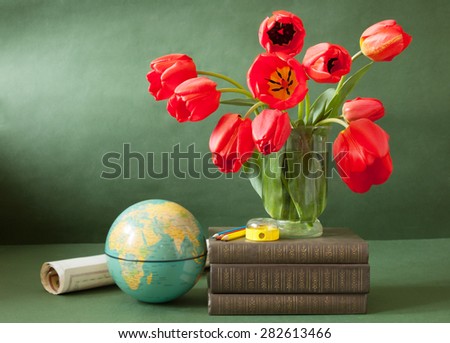 Still life with tulip flowers, globe, map and books isolated on artistic background. Teacher\'s day concept