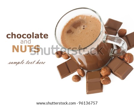 Hot chocolate in cup with chocolate bar pieces and hazelnuts isolated on white with sample text