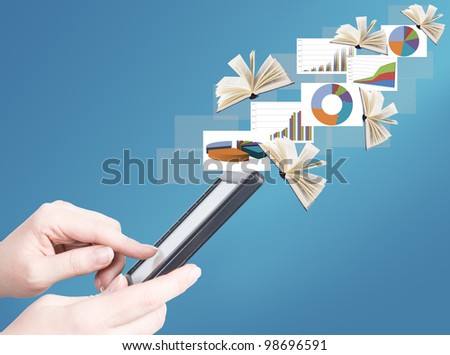 Hand holding electronic book and opened books and business diagrams flying away (education and business news concept)