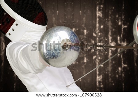 fencer athlete with sword and mask in action