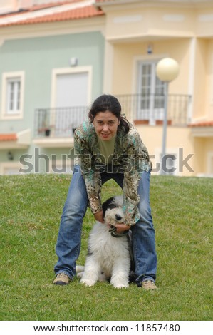 Happy woman with her dog (baby Old English Sheepdog)
