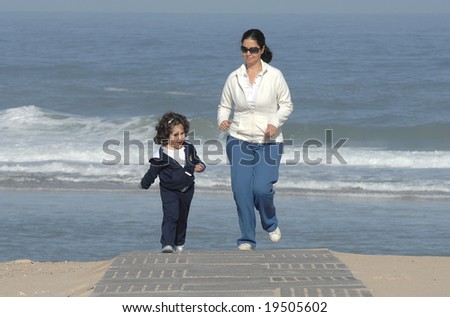 mother and is daughter running at the beach