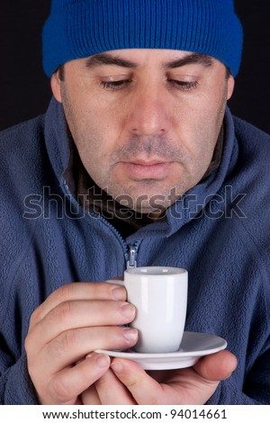 Middle age having cup of coffee isolated on black background