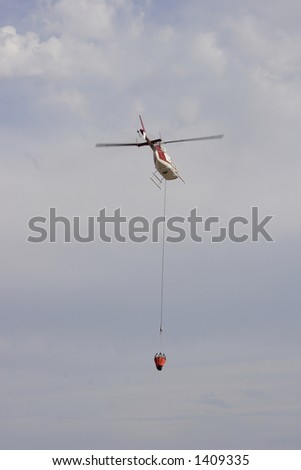 Fire fighting helicopter flying away
