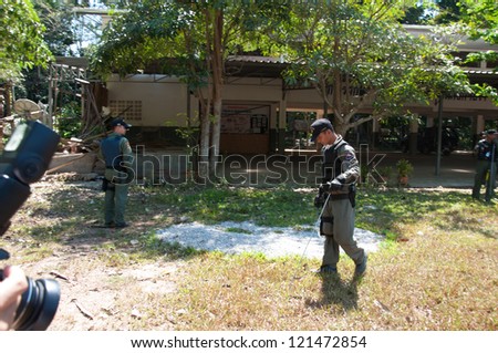 YALA, THAILAND - FEB 23: Explosive Ordnance Disposal Police search for time bomb after time bomb explode on Feb 23, 2012 at Yaha Samukkee School Yala, Thailand