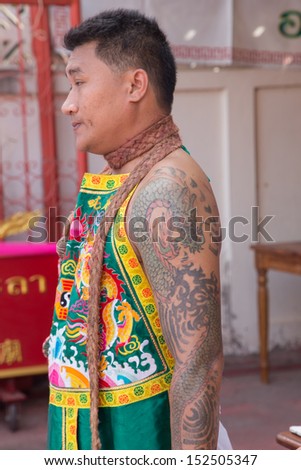 Yala, Thaland - July 18: Dragon Tattoo on Medium male\'s arm in sacrifice to Tabtim goddess ceremony on July 18, 2013 at Tabtim goddess shrine Aumphor Muang, Yala Province, Thailand.