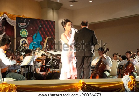 YALA, THAILAND - DECEMBER 2: Unidentified singer performs for Yala Orchestra Concert in Orchestra Concert for King on Dec 2, 2011 at Meeting Hall Rajabhat University Yala, Thailand