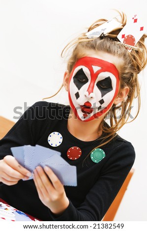 Young girl painted a colorful poker face