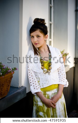 Teenage fashion girl showing off clothes and jewelry on location