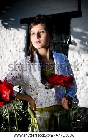 Teenage fashion girl showing off clothes and jewelry surrounded by huge red poppies