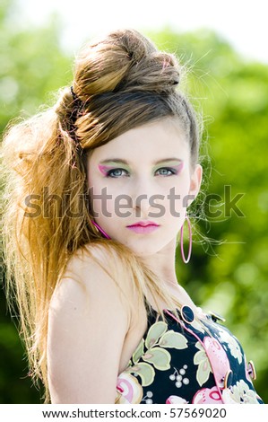 Closeup teenage girl model presenting clothes in the park natural background