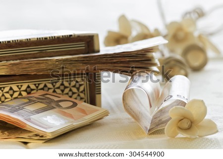 Fifty euro banknotes, gift box and flowers bounquet