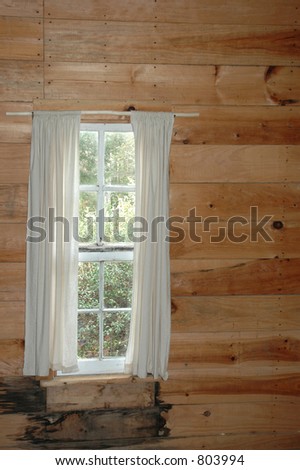 Window inside of a rustic cabin,