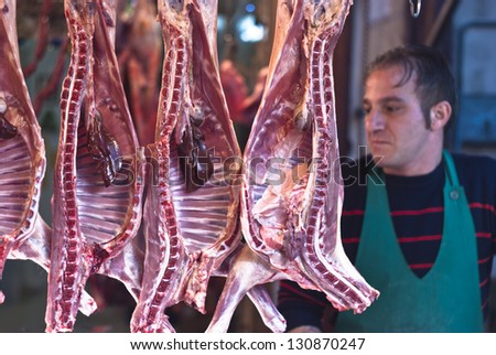PALERMO - DECEMBER 29: butcher sells meat on the local market in Palermo, called Ballaro. This market is also tourist attraction in Palermo, Sicily, Italy on Dec. 29, 2012.