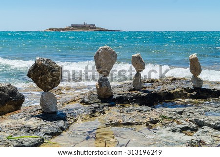 Balanced stones near island of currents in Sicily. Italy