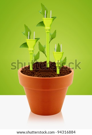 producing electricity from green ways, three green electricity plug with green leaves into clay garden pot.