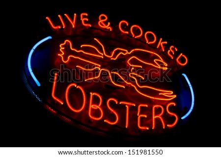 Live and cooked lobsters old and dusty vintage fluorescent neon store sign at a fish market