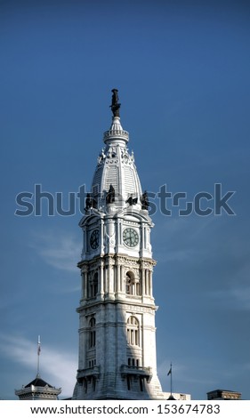 William Penn bronze statue atop clock tower above Philadelphia City Hall Second empire style building as house of local Philly government in Pennsylvania