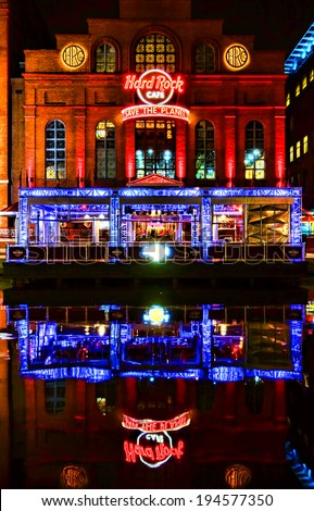Baltimore, Maryland - Circa 2014: Hard Rock Cafe restaurant and music entertainment bar facade storefront with bright colorful neon signs and reflections in the water at night