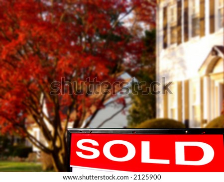 Real estate sold insert rider on Realtor lawn sign with white colonial style house for sale