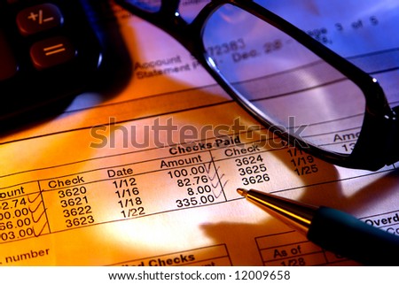 Pen on a bank checking account financial statement with glasses and calculator for budgeting and reconciliation