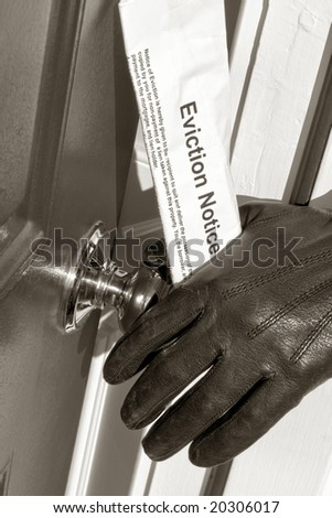 Sheriff deputy hand with leather glove opening a house door while holding a court ordered home eviction notice and serving legal documents for a lawful home repossession