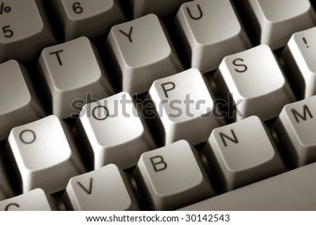 The word oops with an exclamation mark spelled with modified keys on a special computer keyboard as a metaphor for a typing mistake