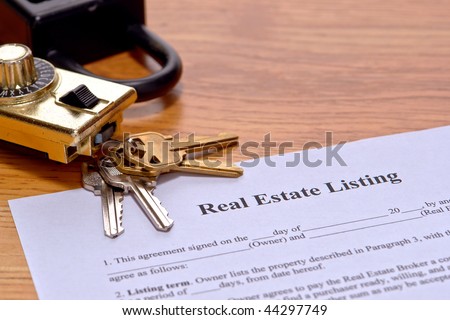 Real estate broker listing home seller document on Realtor desk with house keys and safety showing lock box on realty agent office desk
