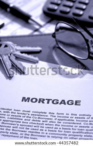 Real estate lending broker home mortgage loan document with keys and glasses on a financial banking lender agent desk (fictitious document with authentic legal language)