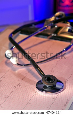 Medical doctor stethoscope over ECG Graph result on a clipboard in a hospital emergency room
