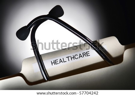 Medical doctor stethoscope inside a file folder with healthcare title tab in a health care provider office