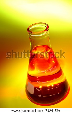 Laboratory glass Erlenmeyer flask filled with red chemical liquid for a chemistry experiment in a science research lab