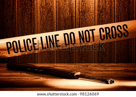 Police line do not cross safety warning tape at forensic murder crime scene with shotgun weapon shooting evidence on floor during a criminal law justice investigation in rough grunge sepia