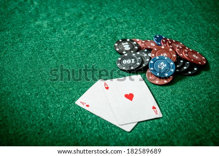 aces and chips on a green felt