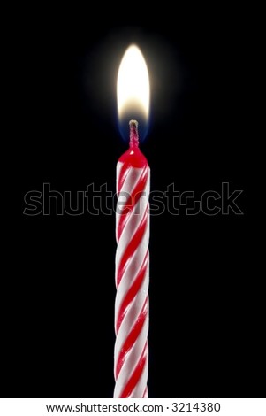 One lit birthday candle isolated over black.