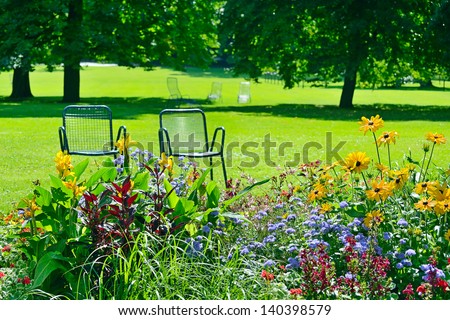 Chaise lounge for recreation near flowerbed