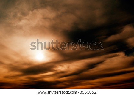 The sun on background black clouds.