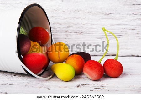 Bright Fruit shaped candies in macro image of marzipan sweets on the wooden table