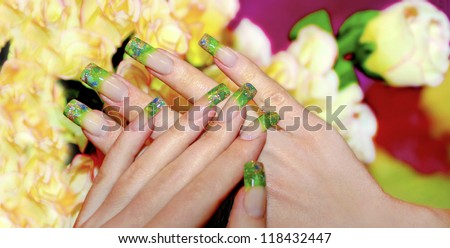 Acrylic nails with bits of green acrylic and Golden sand.