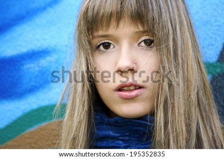 Girl teenager with blond hair and braces mouth and accessory nose