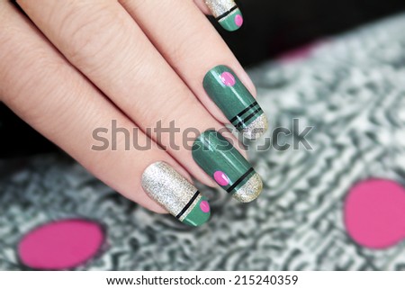 French green manicure with stripes and pink dots graphic background.