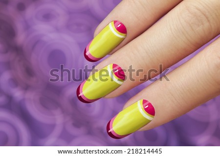 Light green manicure with striped design on oval shaped nails.
