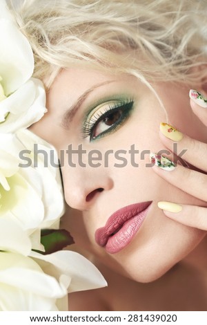 The makeup on the girl with the rose design on nails with roses.