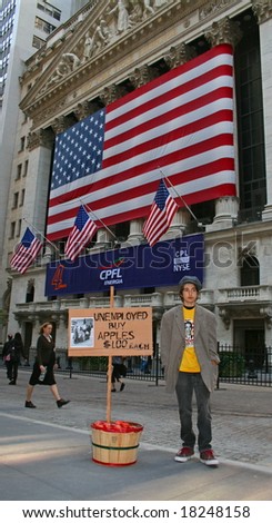 NEW YORK, NY -- SEPTEMBER 30, 2008: A poor boy outside the New York Stock Exchange on September 30, 2008, the day after the record-breaking 777-point drop in the Dow