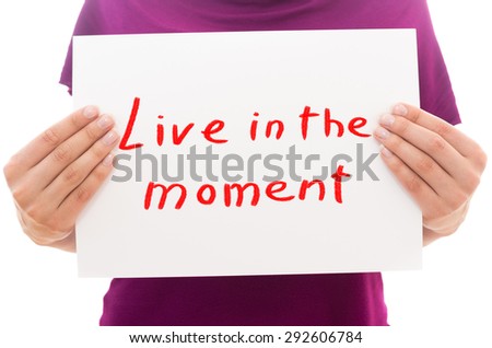 Girl holding white paper sheet with text Live in the moment