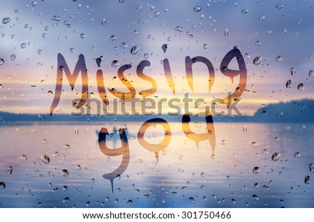 Rain on glass with Missing You text