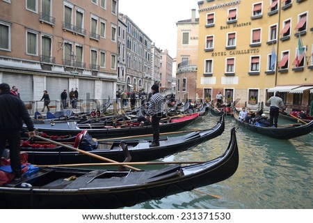 VENICE, ITALY - FEBRUARY 18, 2014: Gondolas on canal in center of Venice, Italy.